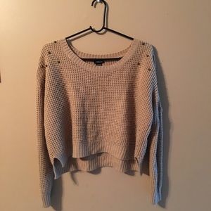 Cropped tan knitted sweater.